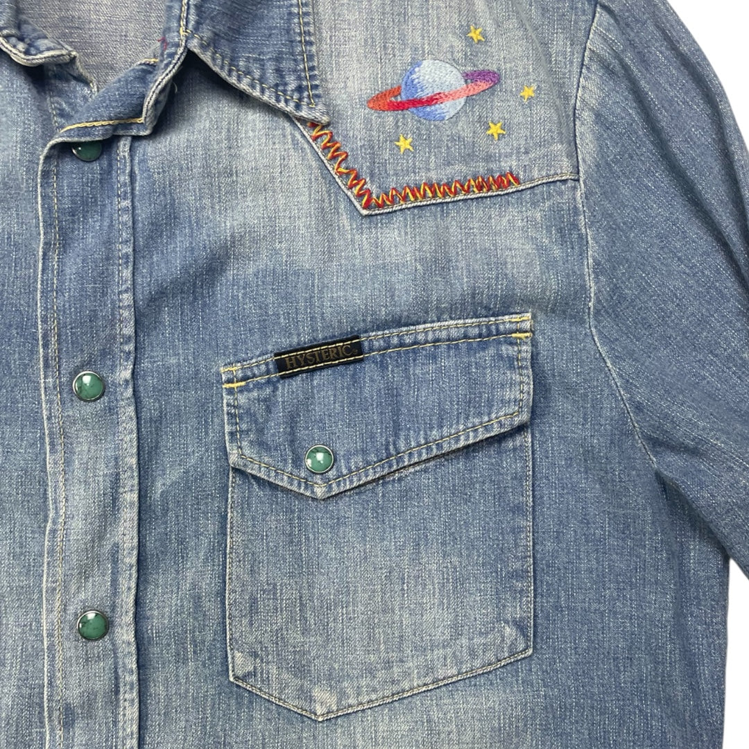 Blue denim shirt with embroidered space-themed design on chest pocket