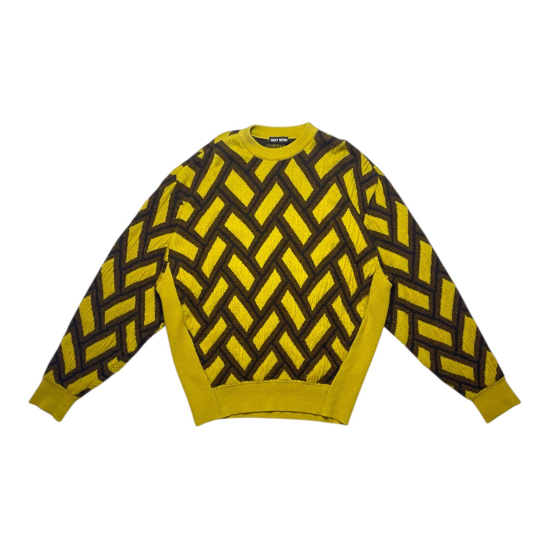 Yellow sweater with black zigzag pattern on a white background